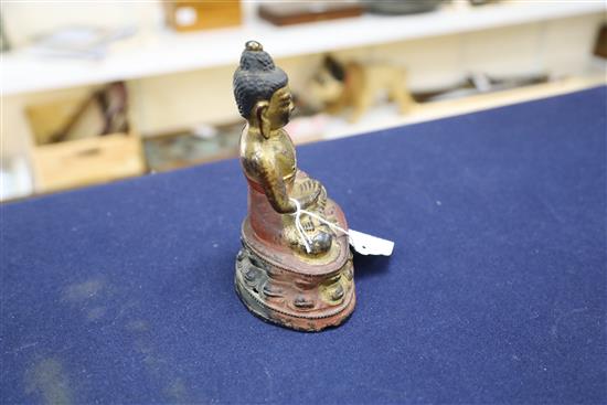 A Sino-Tibetan gilt and polychrome bronze seated figure of Buddha Shakyamuni, 17th/18th century, H. 16.5cm
